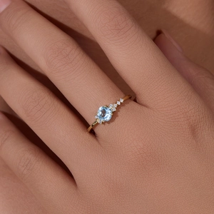 Sky blue topaz sterling silver gold plated ring with side diamonds on model finger
