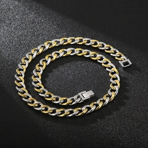 Detail of two-tone gold and silver Cuban chain necklace with secure rectangular clasp