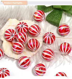 Macro shot of red and white striped pumpkin beads with UV colorful coating for DIY jewelry