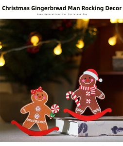 Detail of wooden gingerbread man tumbler figurines with festive Christmas tree background