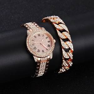 Close-up of rose gold crystal watch and iced-out Cuban link bracelet jewelry set