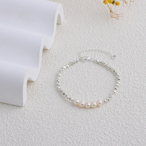 Detail of silver chain necklace with five natural freshwater pearls and irregular beads