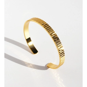 Elegant gold open cuff bracelet featuring a textured vertical stripe design for women