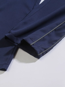 Detailed macro view of dark blue twill fabric with grey reflective safety stripe detail