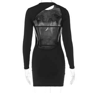 Detail of a black backless long sleeve mini dress featuring asymmetric cutout design