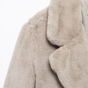Thick beige faux fur coat with oversized lapel collar for warm winter fashion styling