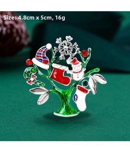 Detailed macro view of Christmas tree brooch with rhinestones and enamel charms