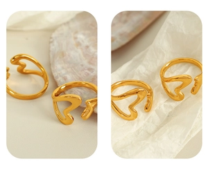 Detail of 18k gold plated hollow heart open rings showing smooth texture and unique design