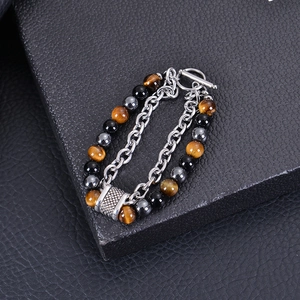 Detail of tiger eye and black obsidian beads with stainless steel OT clasp on men's bracelet