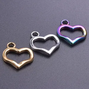 Macro detail of heart-shaped pendants in gold, silver and rainbow plated stainless steel