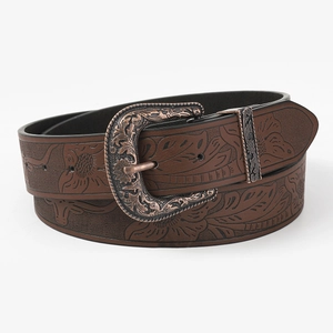 Detail of brown embossed floral leather belt with decorative bronze metal buckle
