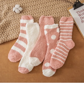 Detail of pink and white coral fleece thermal socks featuring stripes and polka dots