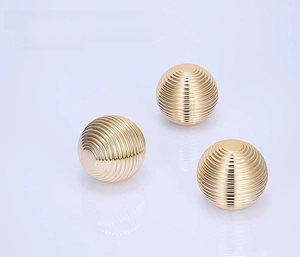Three spherical gold acrylic cosmetic cream jars with metallic rings and shiny finish