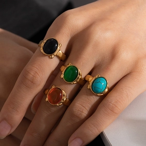 Close-up of vintage titanium steel rings featuring various colorful oval natural stones