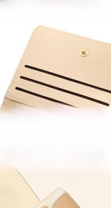 Detail of apricot pebbled leather wallet featuring multiple card slots and metal snap button