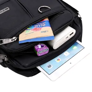 Black Oxford cloth shoulder bag with multiple compartments showing high storage capacity
