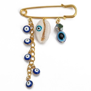 Golden safety pin brooch with blue evil eye charms, natural shell, and faceted bead pendant