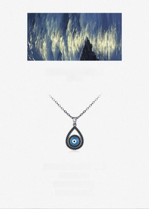 Macro view of S925 silver devil eye pendant with black crystals and blue center