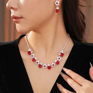 Zircon flower necklace and earring set with red crystals worn on a model
