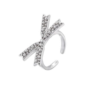 Macro shot of silver ring with beaded metal bow ornament and polished open band detail