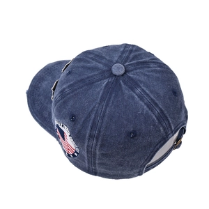 Detailed macro view of navy washed denim baseball cap with side American flag embroidery