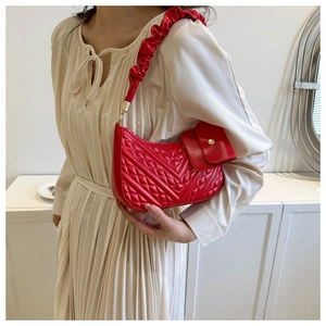 Red quilted cloud bag detail showing the ruffled shoulder strap and matching coin purse