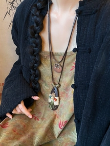 Detailed view of Bohemian water-drop necklace with bowknot and tassel decoration
