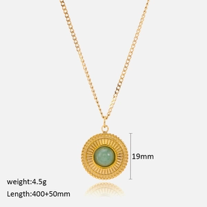 Detail view of round green aventurine pendant necklace with sunburst metal pattern