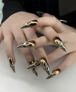 Macro shot of 3D flame pattern on gold and silver metallic stiletto press-on nails