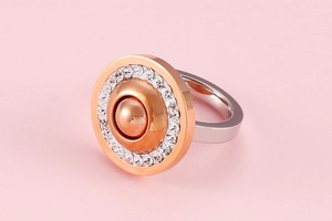 Detail of two-tone stainless steel ring with rose gold disc and micro-pave white zircons