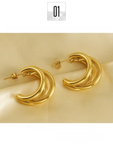 Detail of 18K gold-plated titanium steel layered C-shaped hoop earrings on silk