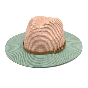 Detail of two-tone straw fedora showing nude pink crown and mint green brim with belt