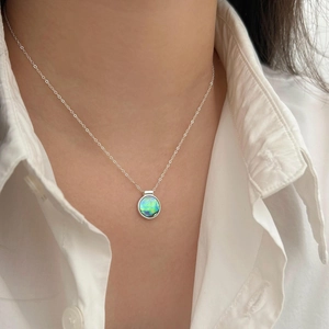 Vintage 925 sterling silver necklace with iridescent abalone shell pendant on a model