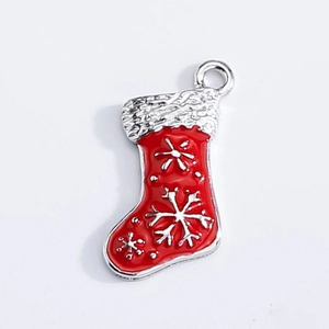 Detail of red and silver Christmas stocking charm with snowflake pattern for DIY jewelry