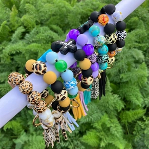 Detailed collection of silicone leopard print bead bracelets with cross and tassel