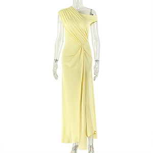 Detail of light yellow one-shoulder maxi dress with pleated waist and draped fabric