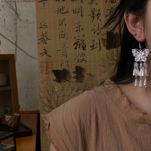 Hollow butterfly earrings with long tassels and water drop pendants in silver finish