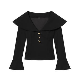 Elegant black V-neck top with golden buttons and flared sleeves in a minimalist flat lay