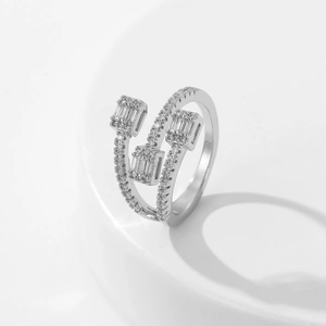 Detailed macro view of silver open ring with triple rectangular zircon cluster settings
