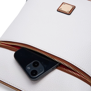 Macro detail of white lychee leather bag showing front pocket storage for a smartphone