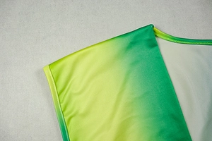 Detail of V-neck stitching and green-to-yellow gradient on slim knit dress