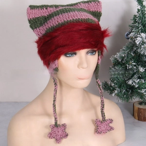Detail of hand-knitted cat ear hat featuring pink-green stripes and faux fur trim