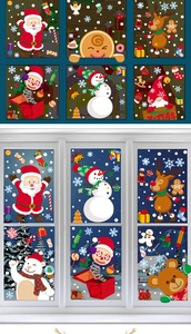 Detail of Christmas window stickers with Santa, snowman and elk on a glass window frame