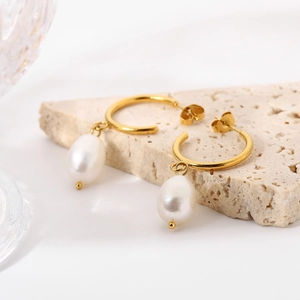 Elegant gold stainless steel earrings featuring natural white baroque pearl pendants