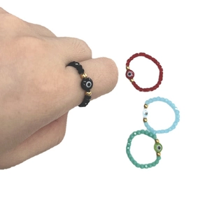 Elastic beaded Evil Eye ring set in black, red, blue, and green colors for women