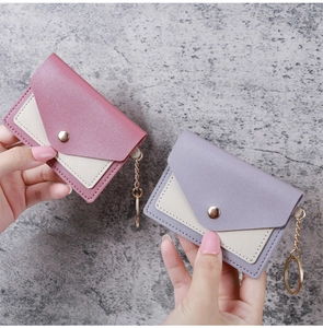 Detail of pink and purple PU leather envelope card holders with gold keychains
