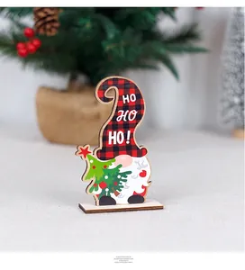 Detailed view of a wooden Christmas gnome decoration with HO HO HO text and tree