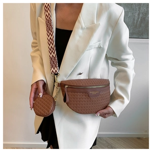 Detail of woven crescent crossbody bag with round pouch and jacquard strap on model