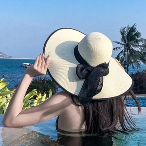 Wide brim straw sun hat with black mesh bow tie for summer beach vacation