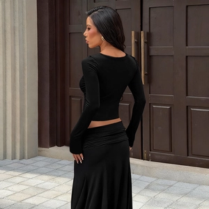 Detail of black long sleeve lace trim top and skirt set with a slim fit cropped design